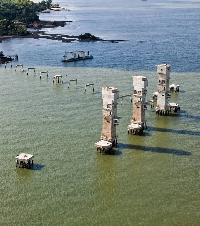 Construção de estrutura fluvial com pilares de concreto sobre rio